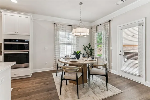 a view of a dining room with furniture window and wooden floor
