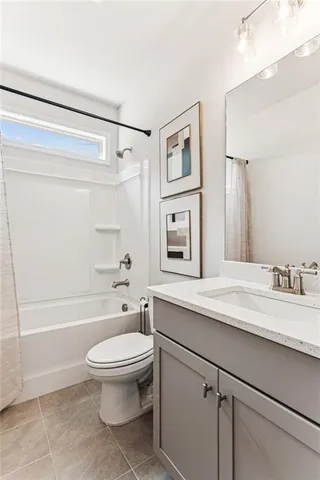 a bathroom with a granite countertop sink toilet a shower and a mirror