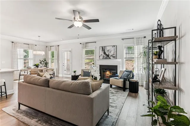 a living room with furniture a fireplace and a window