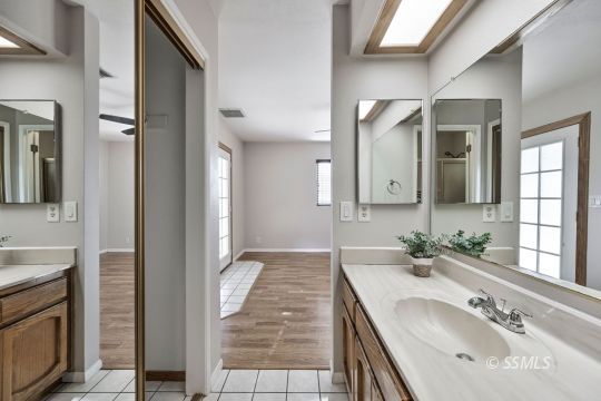 407 South Sunland Street Ridgecrest, CA 93555 - Photo 24 of 28 a bathroom with a double vanity sink and a mirror