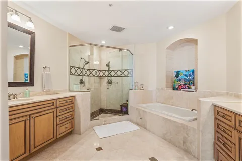 a bathroom with a tub a sink and a shower