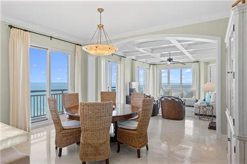 a dining room with furniture a chandelier and fireplace