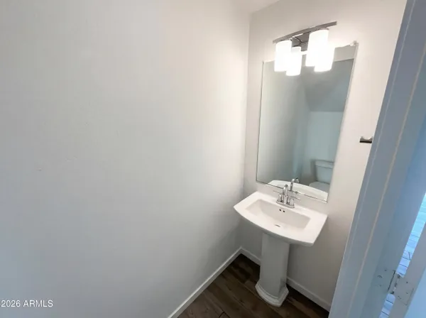 a bathroom with a sink a mirror and a toilet