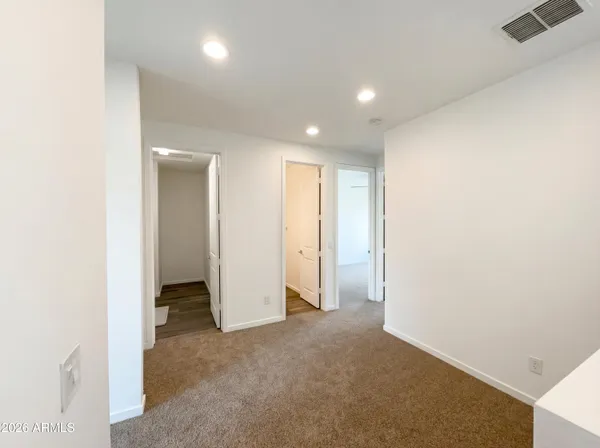 an empty room with closet and a bathroom