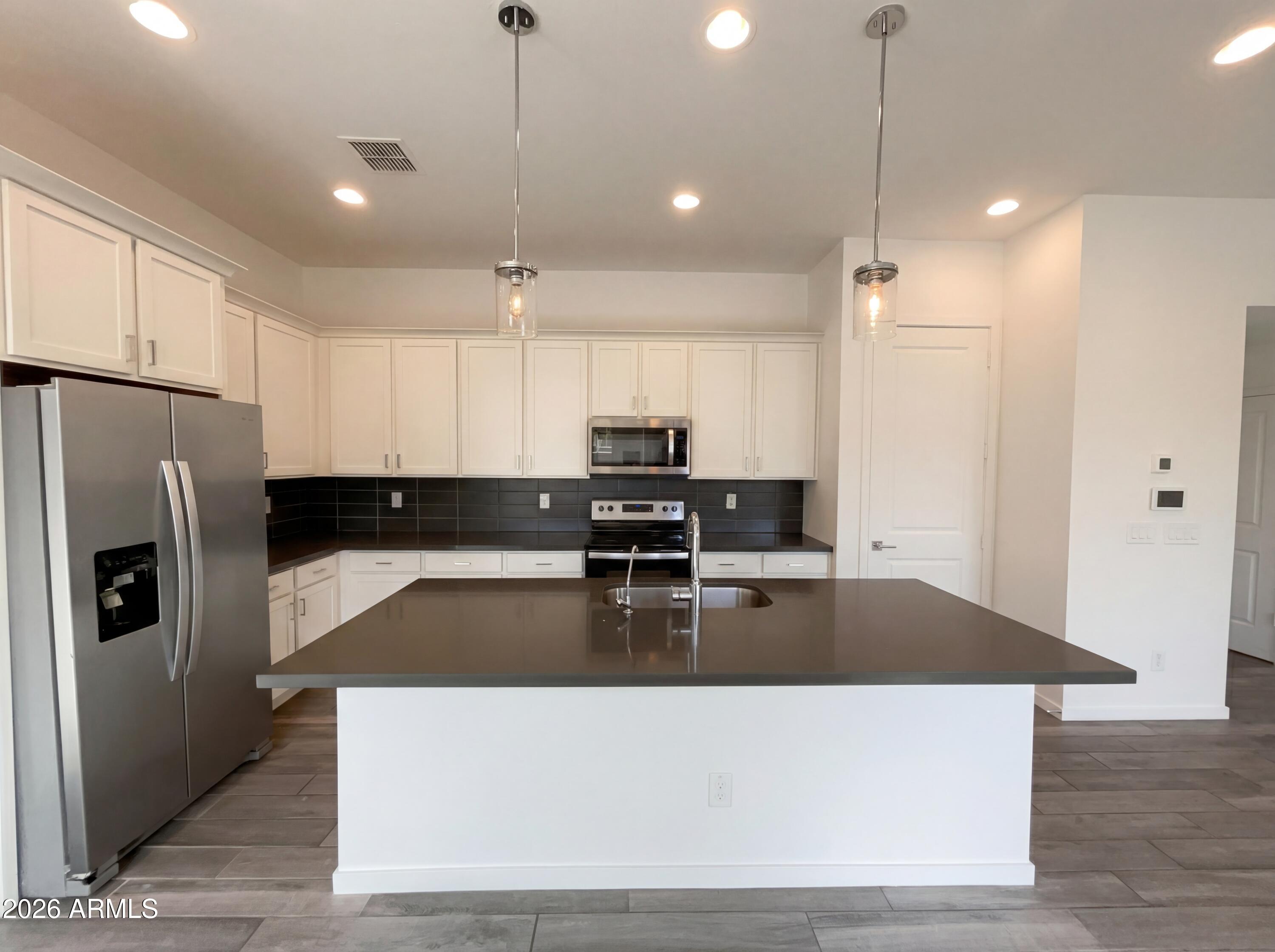 901 South Smith Road, Unit 1074 Tempe, AZ 85281 - Photo 2 of 23 a large kitchen with stainless steel appliances granite countertop a refrigerator a sink a stove and a granite counter top
