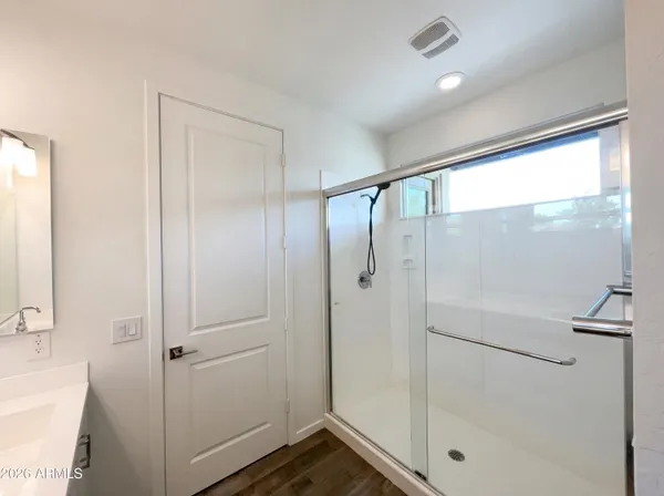 a bathroom with a glass shower door