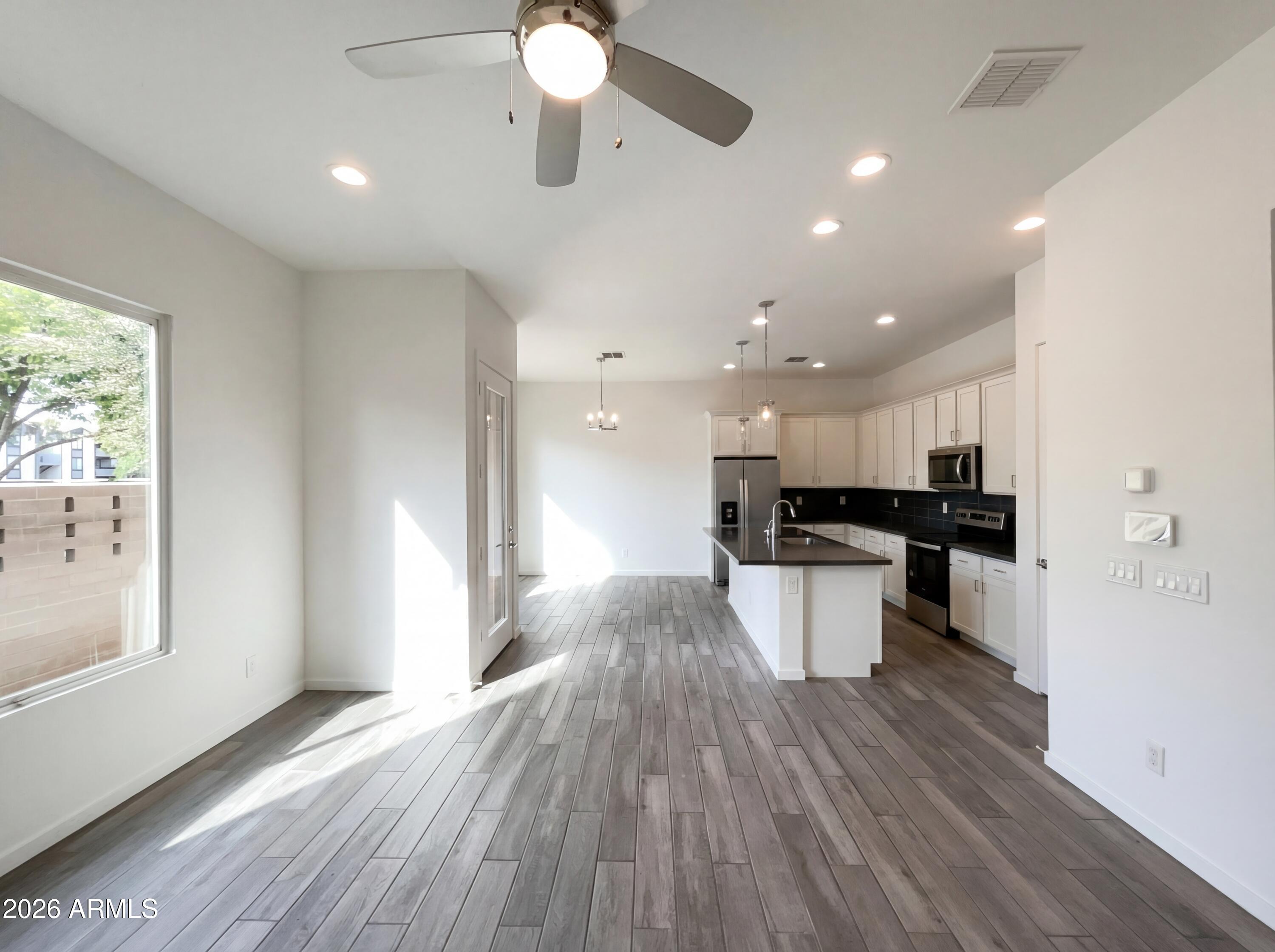 901 South Smith Road, Unit 1074 Tempe, AZ 85281 - Photo 3 of 23 a view of kitchen with kitchen island stainless steel appliances sink refrigerator and stove