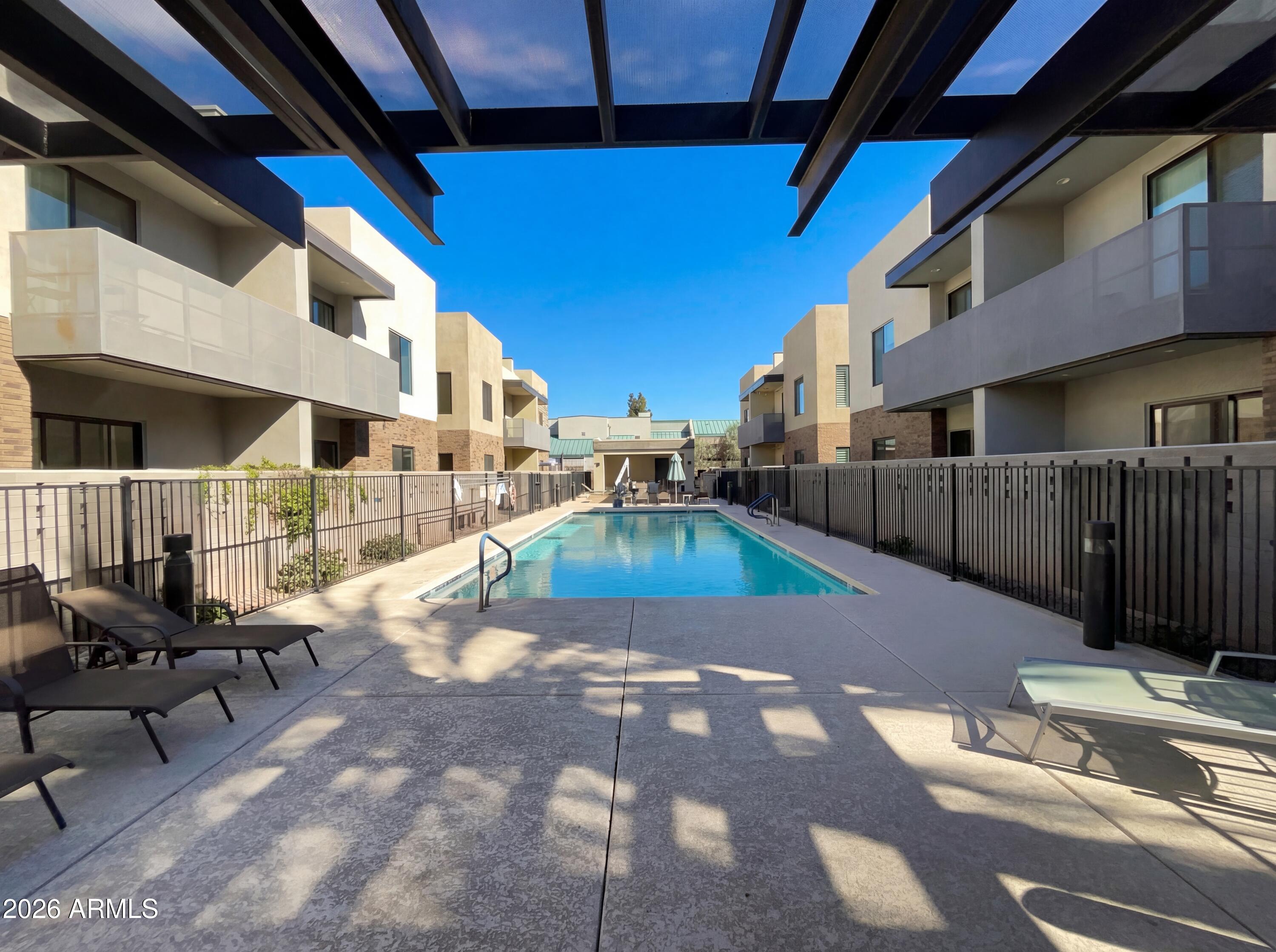 901 South Smith Road, Unit 1074 Tempe, AZ 85281 - Photo 7 of 23 a view of a porch with furniture and floor to ceiling window
