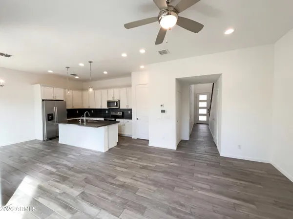 a view of kitchen with refrigerator and microwave