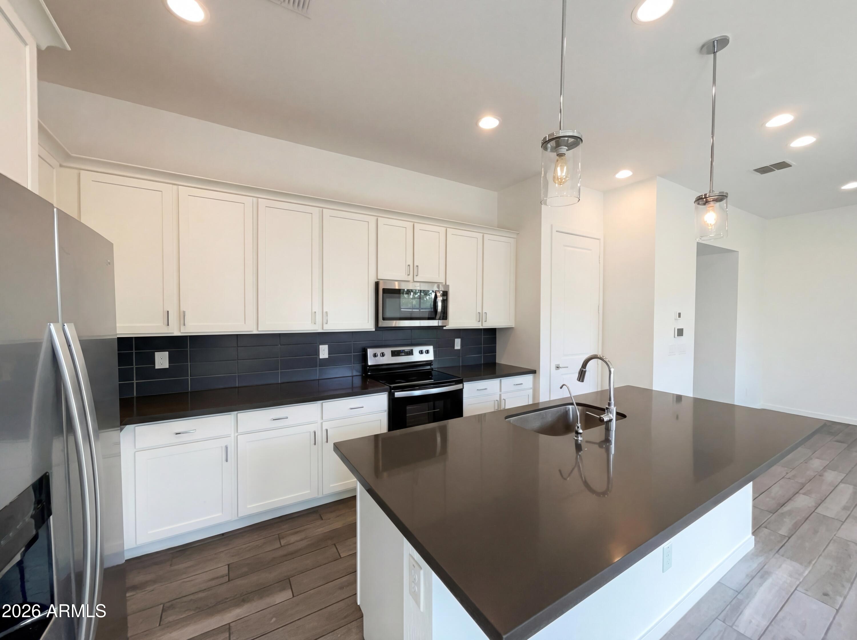 901 South Smith Road, Unit 1074 Tempe, AZ 85281 - Photo 10 of 23 a kitchen with stainless steel appliances granite countertop a sink a stove and a refrigerator