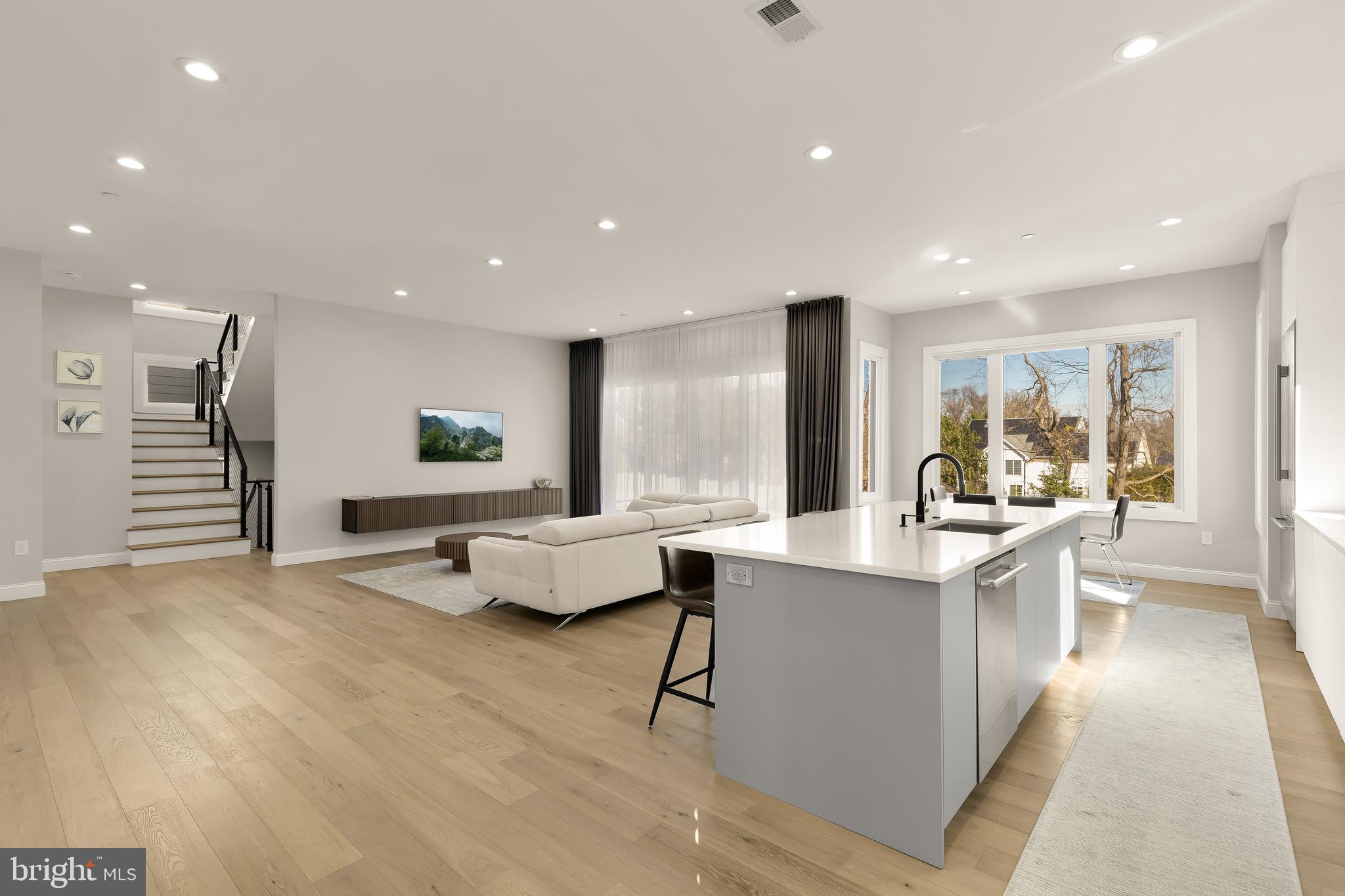 14051 Esworthy Road Darnestown, MD 20874 - Photo 12 of 50 a large kitchen with kitchen island a white counter space a sink a window and stainless steel appliances