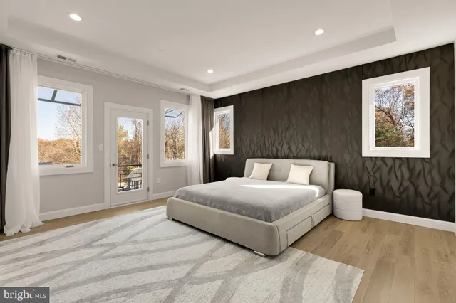 a bedroom with a large bed and a window