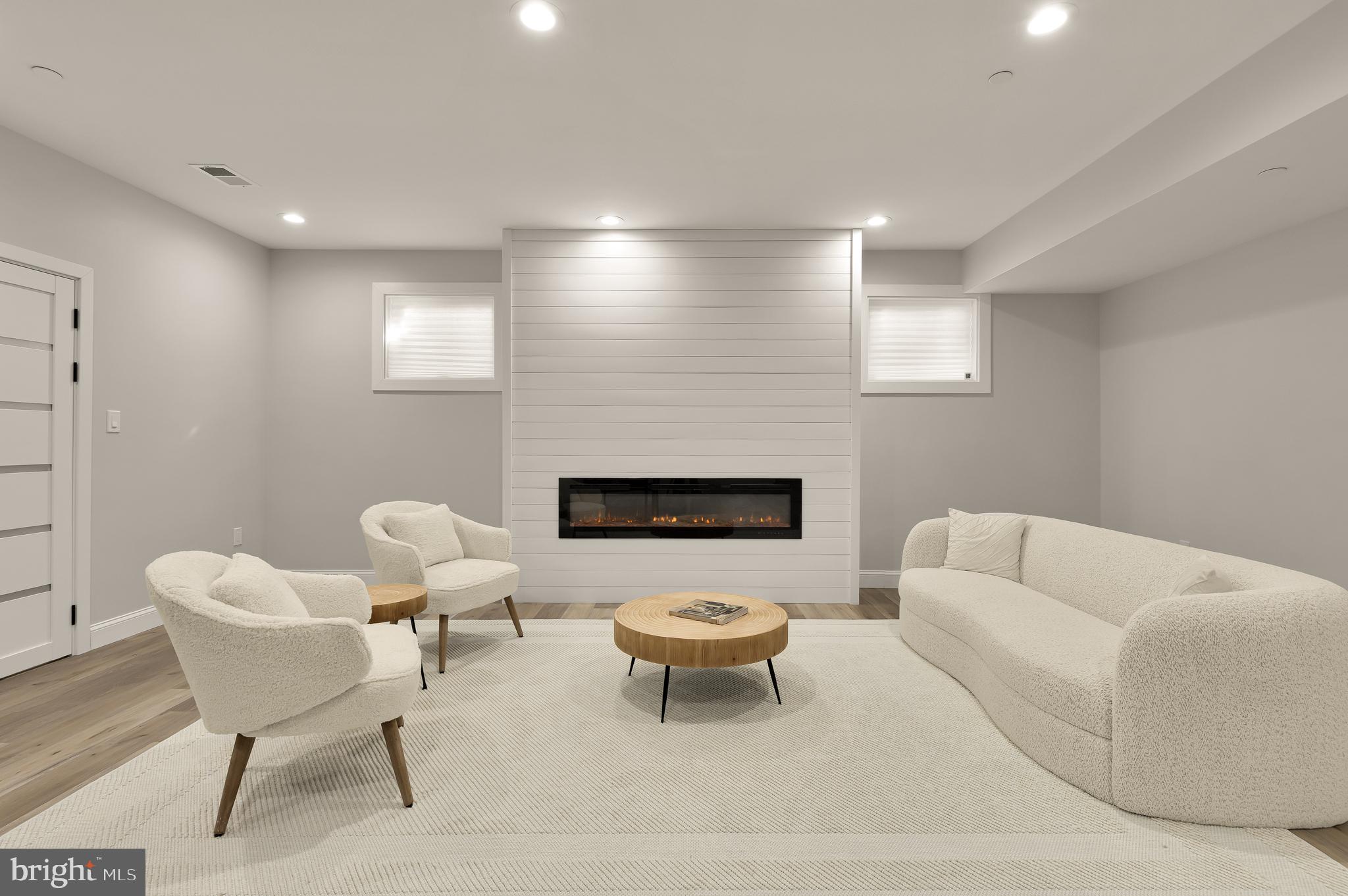 14051 Esworthy Road Darnestown, MD 20874 - Photo 32 of 50 a living room with furniture and a fireplace