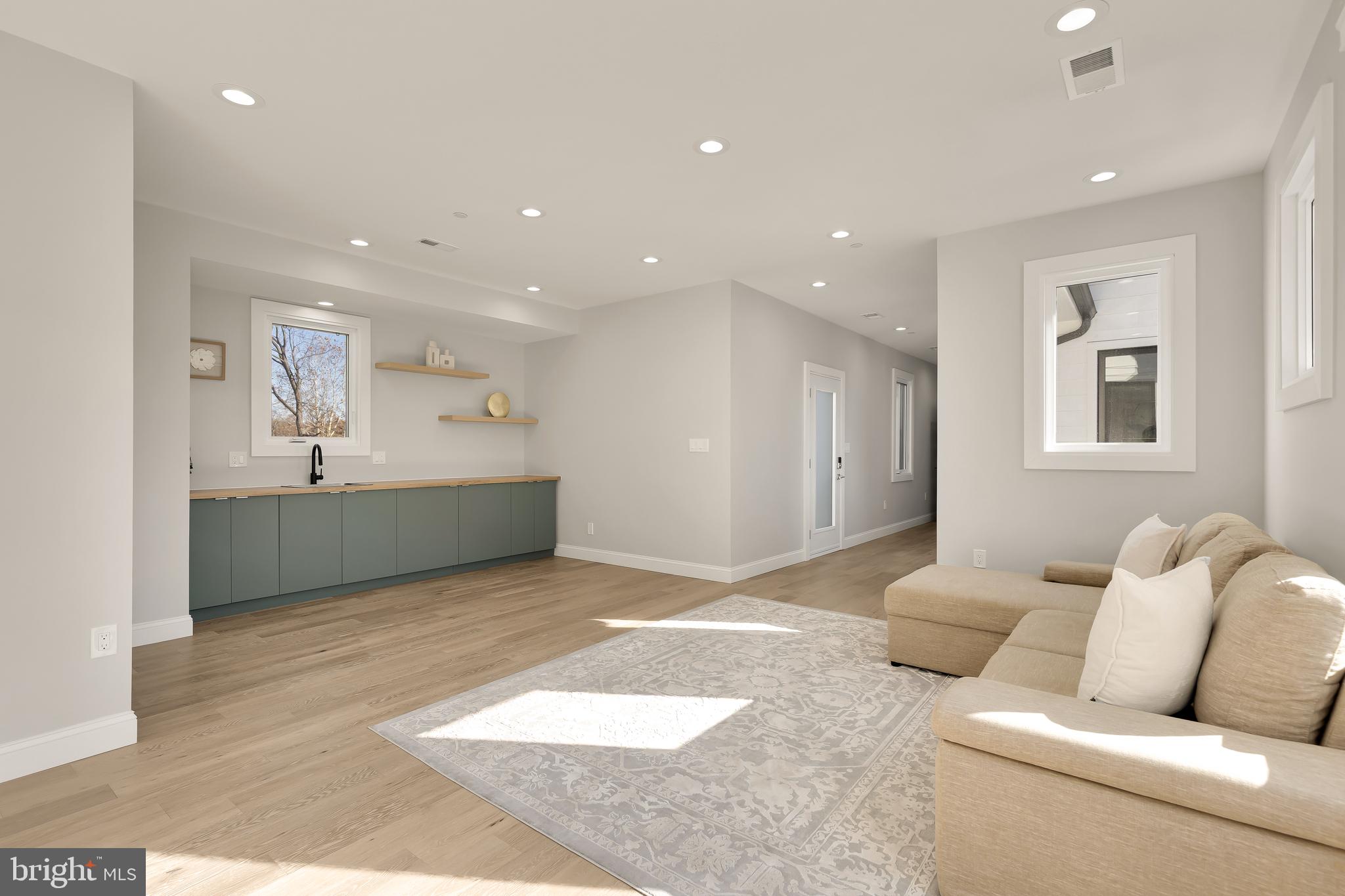 14051 Esworthy Road Darnestown, MD 20874 - Photo 39 of 50 a living room with furniture and a wooden floor