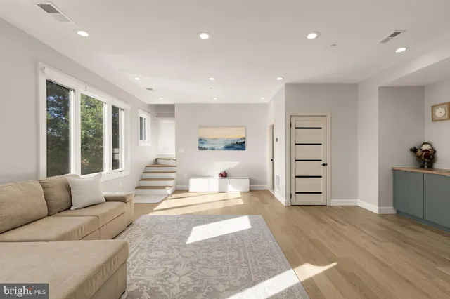 a spacious bedroom with a bed and a painting on the wall