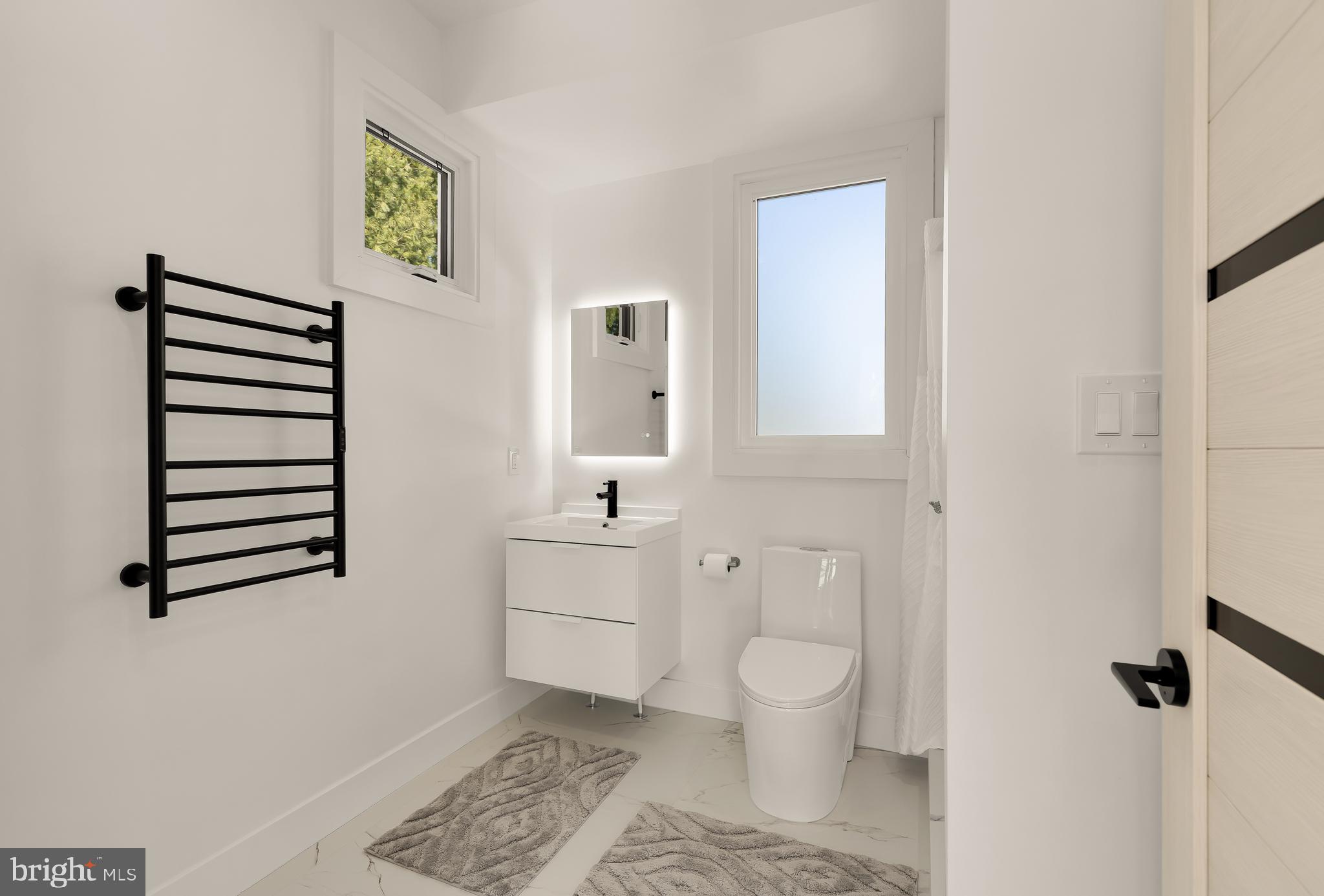 14051 Esworthy Road Darnestown, MD 20874 - Photo 44 of 50 a bathroom with a toilet sink and a mirror