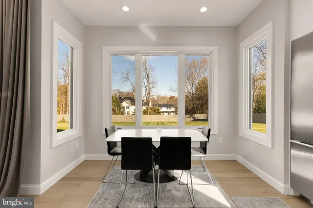 a large white kitchen with a large window