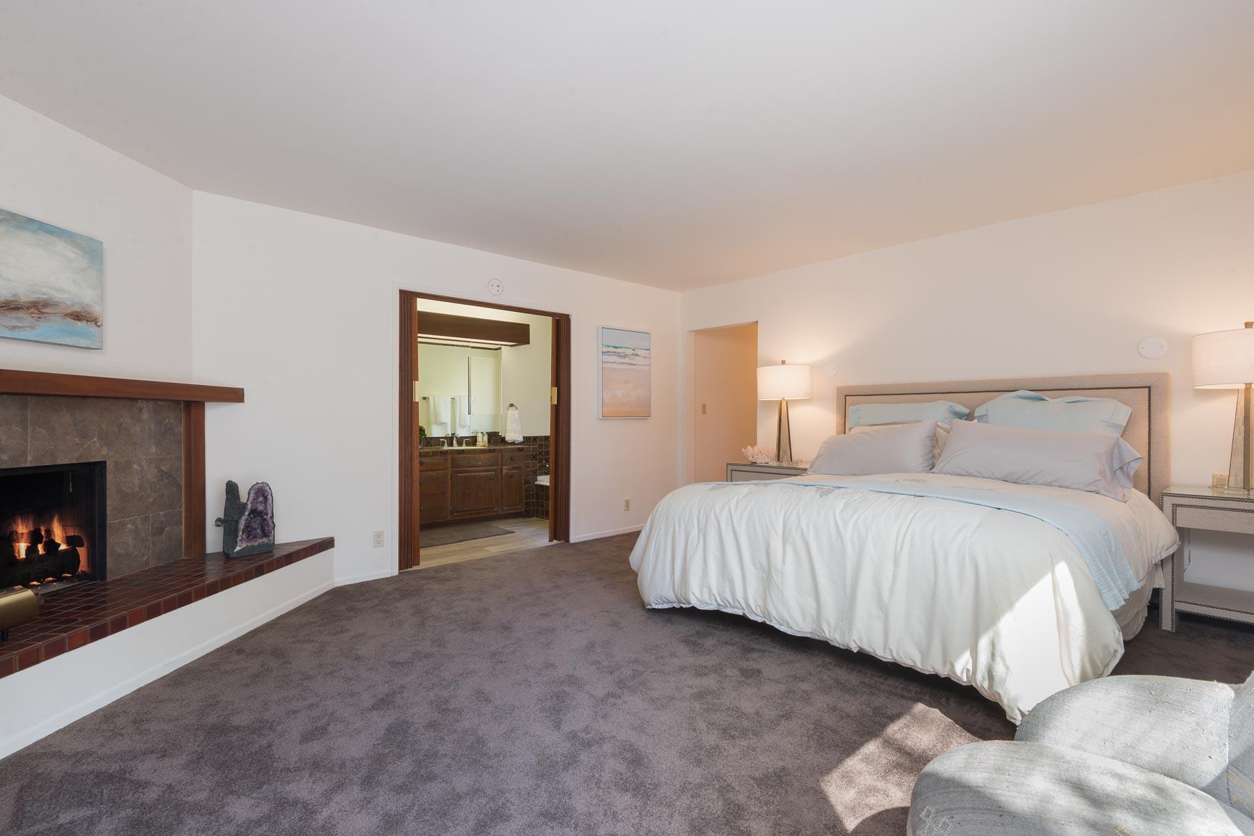 1530 Hillcrest Road Santa Barbara, CA 93103 - Photo 9 of 15 a spacious bedroom with a bed and a fireplace