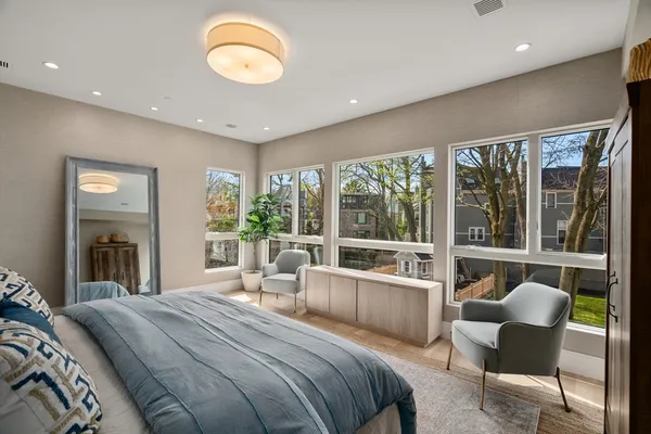 a bedroom with a large bed and a large window
