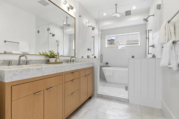 a bathroom with a sink a toilet and shower