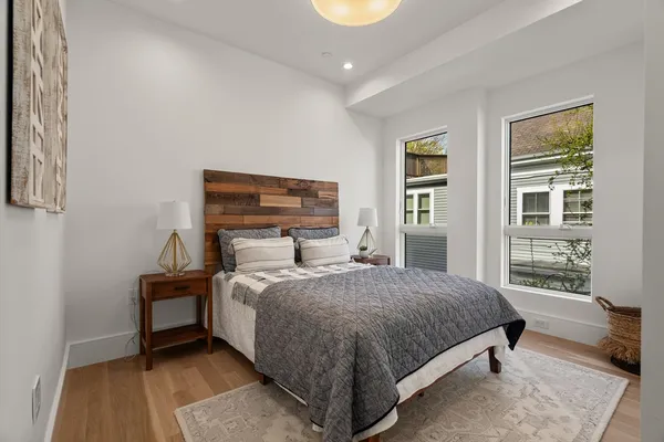 a bedroom with a bed and glass door