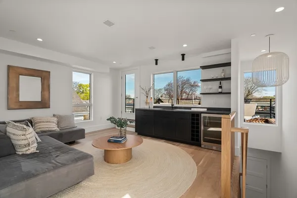 a living room with furniture and a kitchen