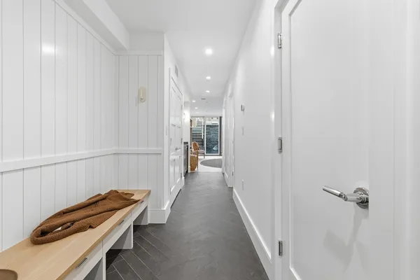 a view of a hallway with wooden floor