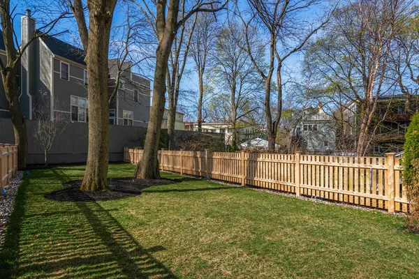 a view of a yard with wooden fence