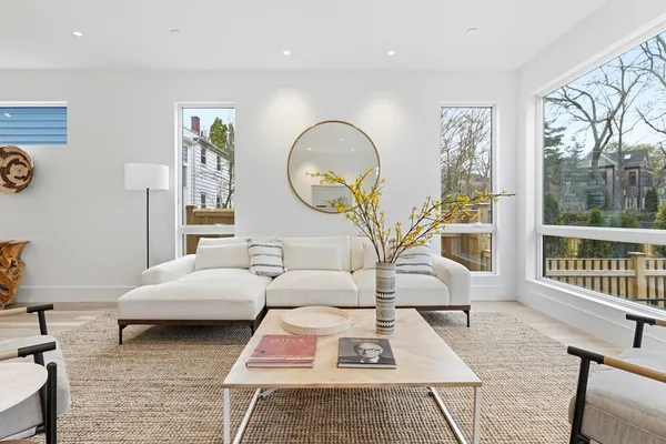 a living room with furniture a rug and a window