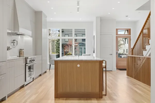 a living room with stainless steel appliances granite countertop furniture and a kitchen view