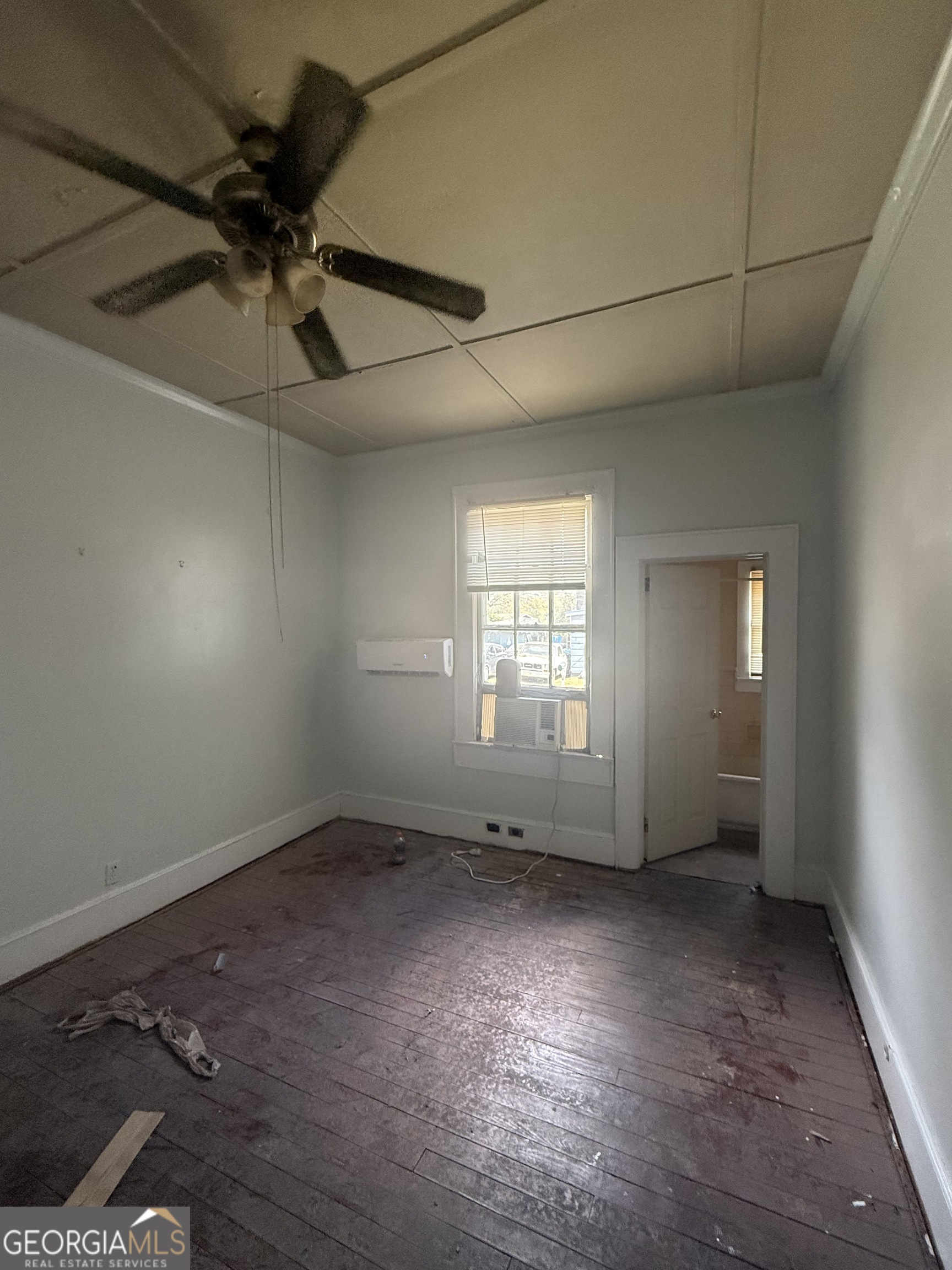 902 1st Street Lanett, AL 36863 - Photo 3 of 6 an empty room with a empty space and windows