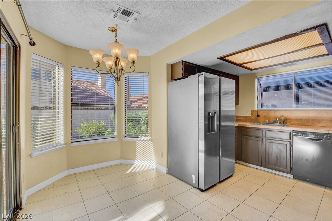 6440 Hartwood Road Las Vegas, NV 89108 - Photo 14 of 59 A well-lit kitchen with a breakfast nook, offering a perfect spot for morning meals.
