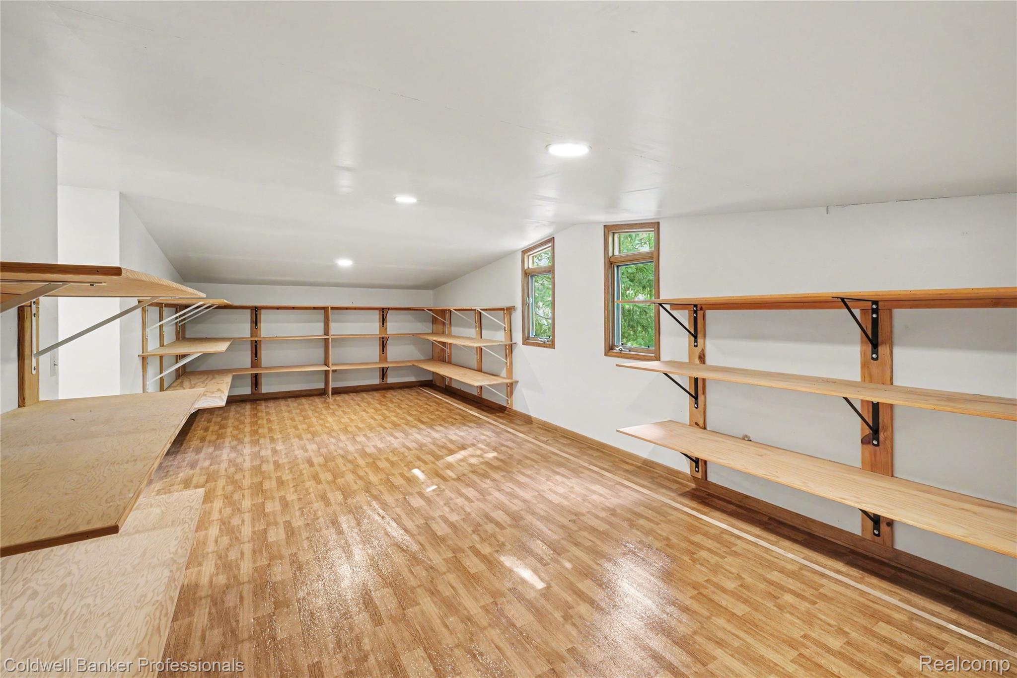3583 Mitchell Road Metamora, MI 48455 - Photo 49 of 58 Spacious room featuring extensive wall-mounted shelving, wood-finish flooring, recessed lighting, and multiple windows with wood trim