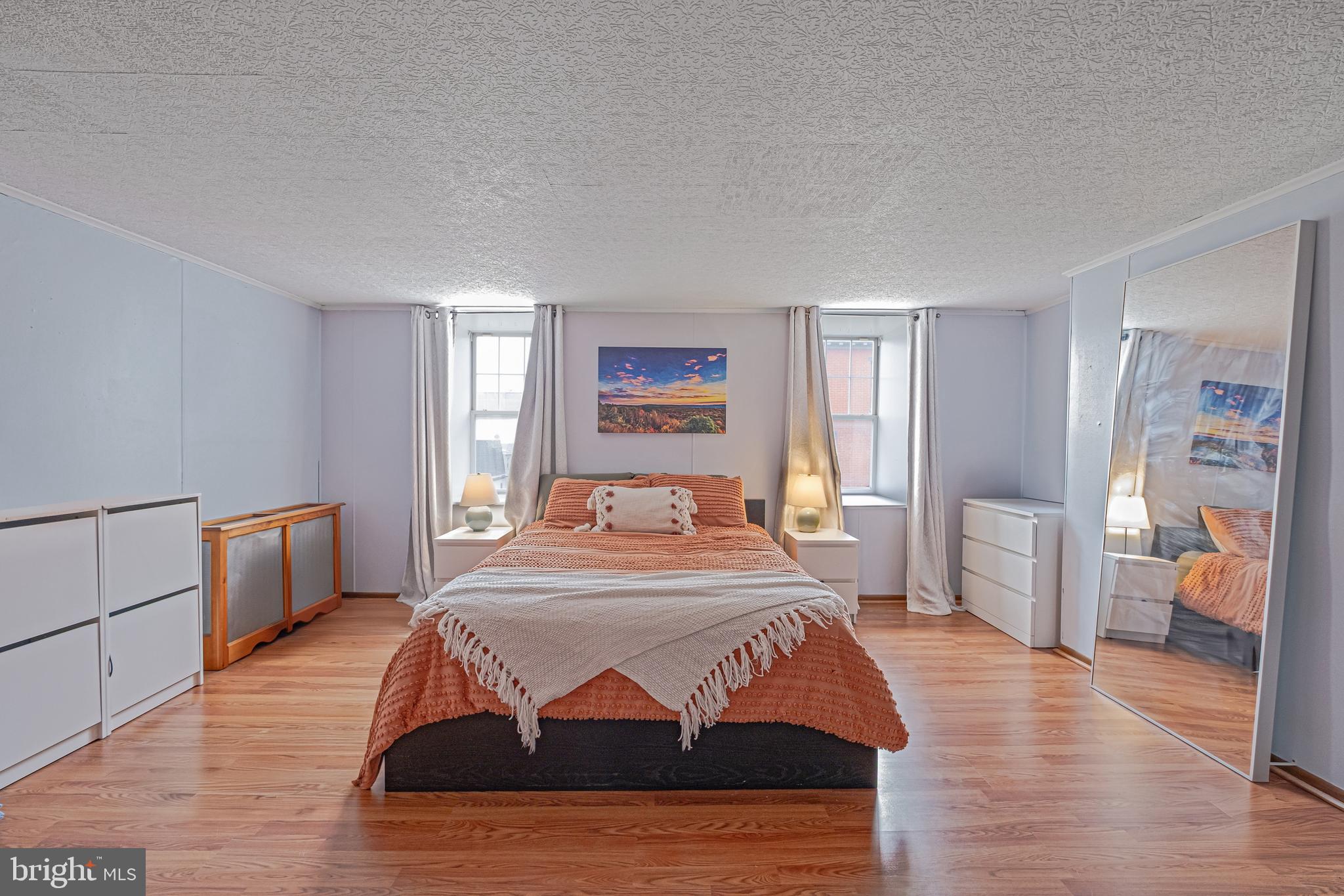 1701 Pine Street Philadelphia, PA 19103 - Photo 12 of 16 a bedroom with a bed and wooden floor
