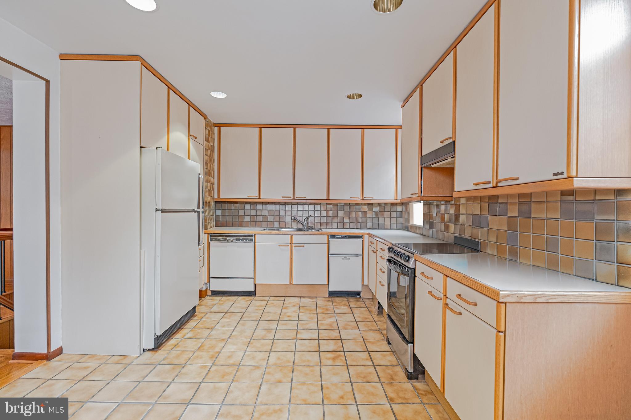1701 Pine Street Philadelphia, PA 19103 - Photo 8 of 16 a kitchen with stainless steel appliances granite countertop a refrigerator and a sink