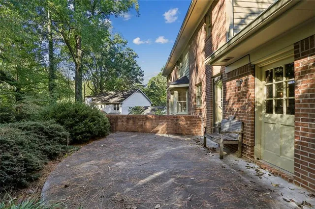 a view of a house with a yard and pathway