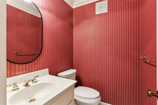 a bathroom with a sink toilet and mirror