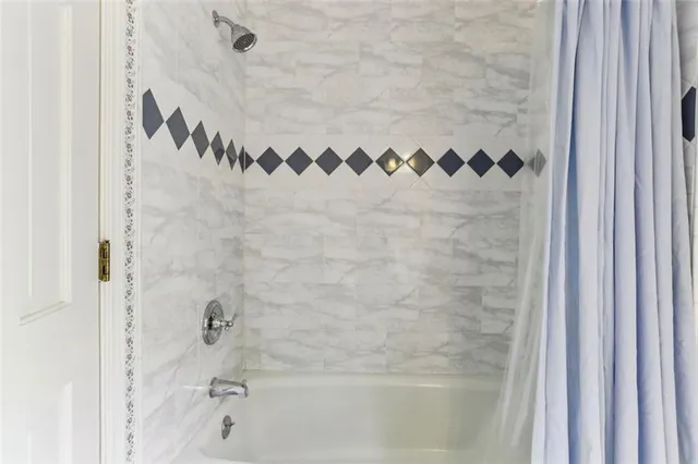 a bathroom with a shower and a bath tub