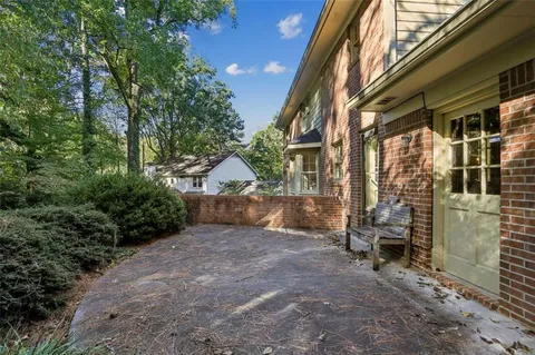 a view of a house with a yard and pathway