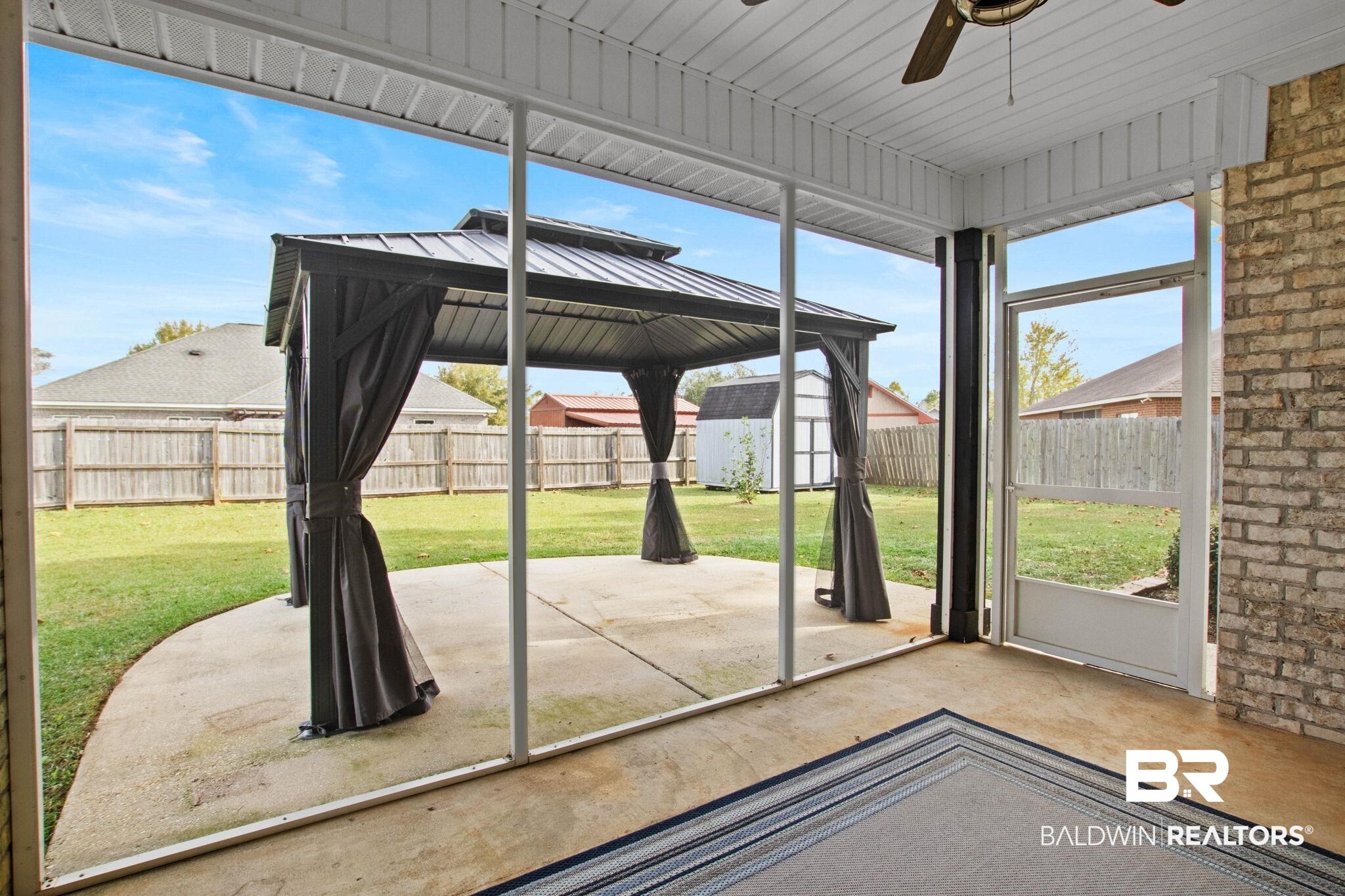 17376 Bankhead Boulevard Fairhope, AL 36532 - Photo 68 of 73 Unfurnished sunroom with a gazebo, ceiling fan, and a patio area