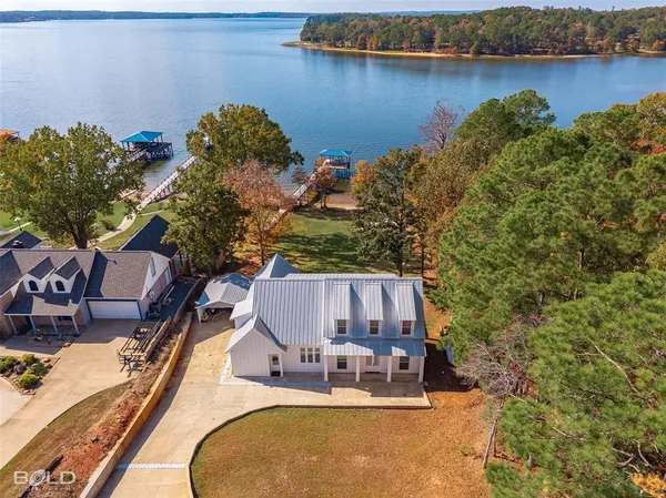 an aerial view of a house with lake view and boat