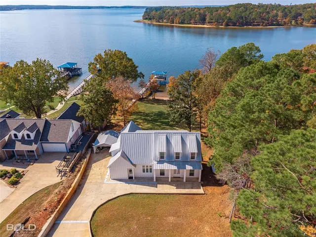 an aerial view of a house with lake view and boat