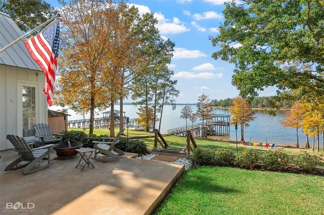 a living room with furniture fireplace and a large window