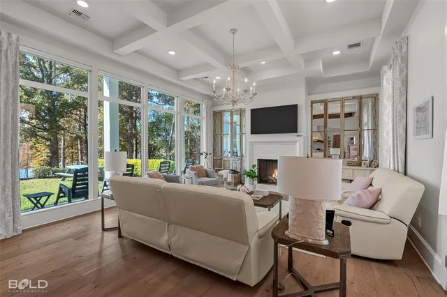 a living room with furniture and a chandelier