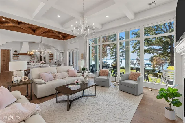 a kitchen with stainless steel appliances kitchen island wooden floors and white cabinets