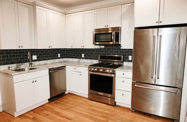 a kitchen with a refrigerator stove and sink
