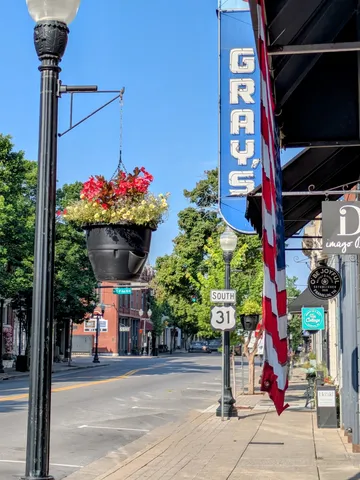 a street sign on a sidewalk next to a building