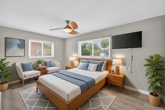 a bedroom with a bed and a painting on the wall