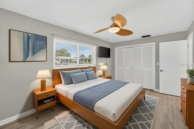 a bedroom with a bed and a flat screen tv