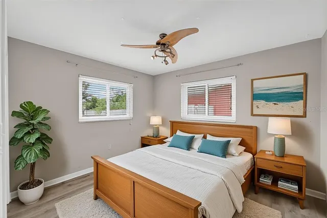 a spacious bedroom with a large bed couch and a window